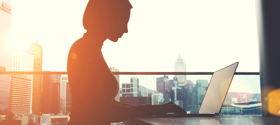 Professional municipal woman working in the city on her laptop managing her assets and infrastructure through a portal on i-Open Technologies planworx software